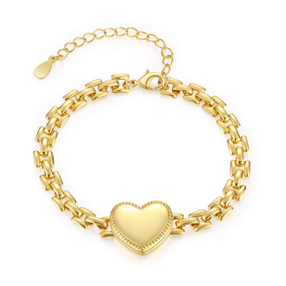 Gold-plated brass heart bracelet with closed locket on white background