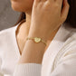 Gold-plated personalised heart bracelet worn with the locket closed