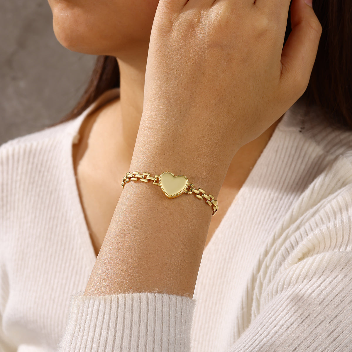 Gold-plated personalised heart bracelet worn with the locket closed