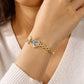 Personalised heart locket bracelet worn on the wrist showing its gold-tone chain