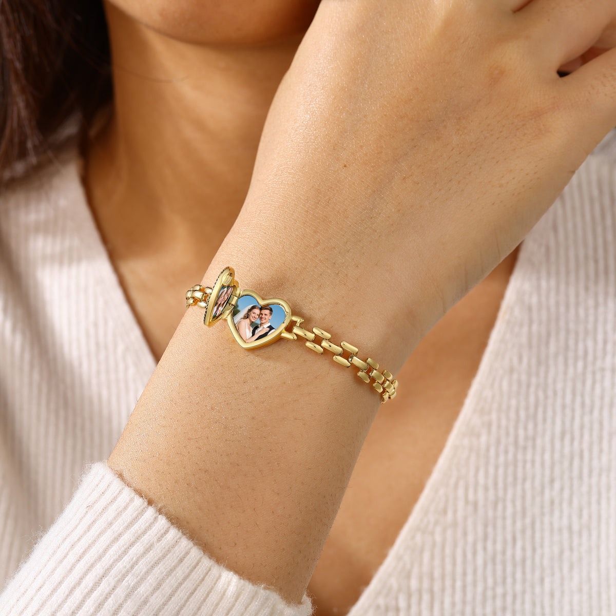 Personalised heart locket bracelet worn on the wrist showing its gold-tone chain